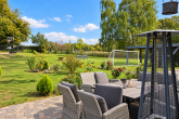 Terrasse und Grundstück im Sommer - Umfassend saniertes, hochwertiges Einfamilienhaus mit Erdwärme und großem Garten bei Rostock